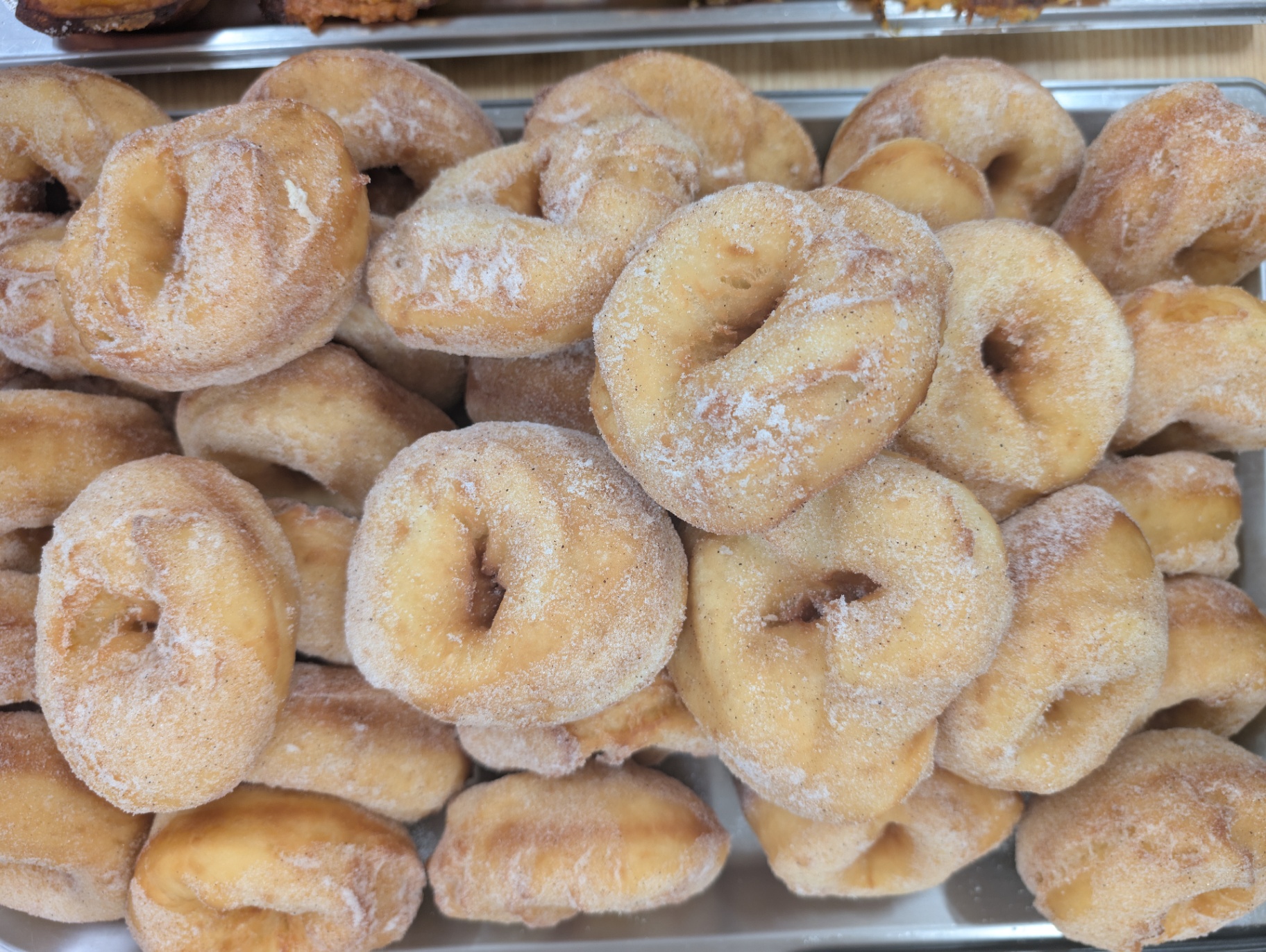 Stack of golden Barney's Sourdough Donuts, freshly sugar-dusted with a crisp crust, slowly fermented for 36 hours and perfect for local pop-ups